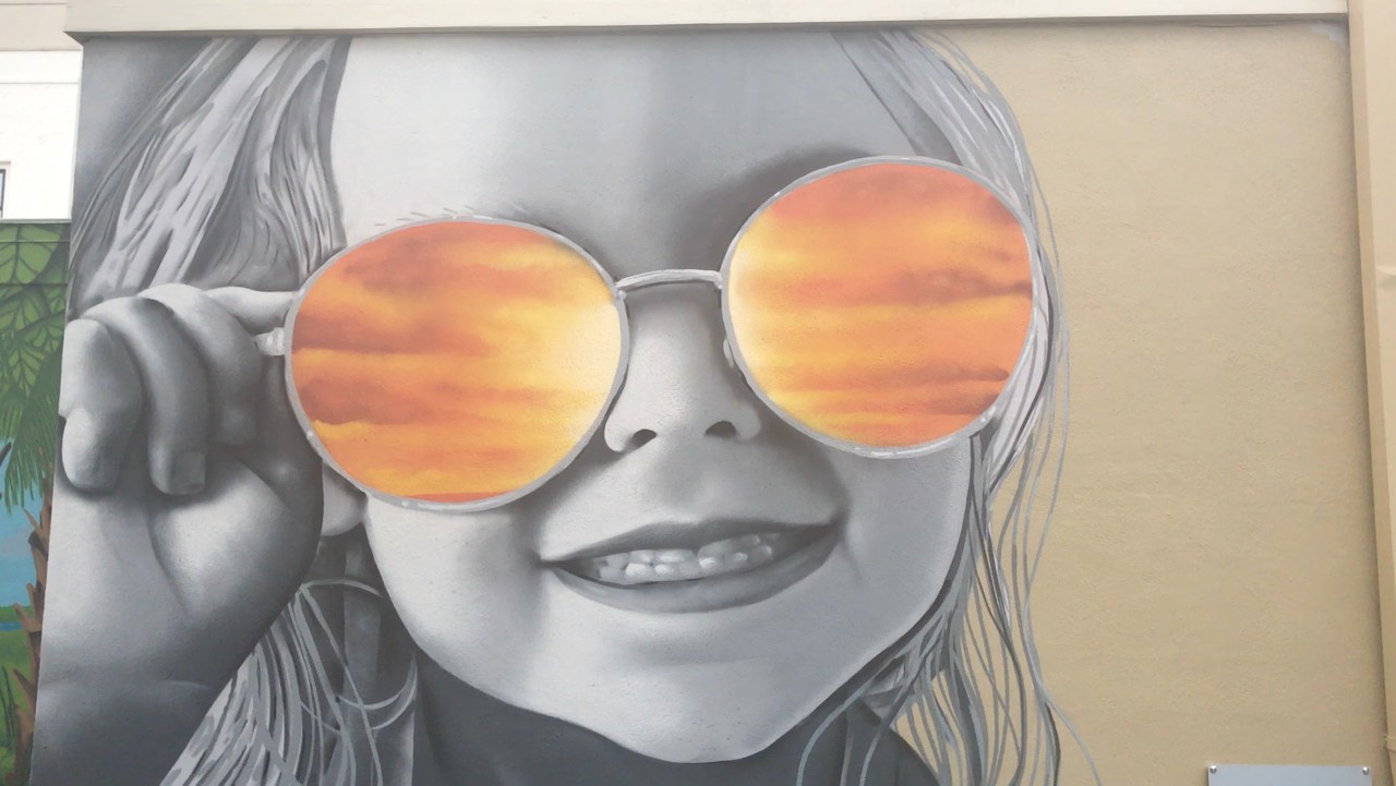 a child sports stylish sunglasses / Moxley photo of street art