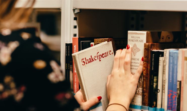A woman selecting a book - image by freestocks.org is licensed under CC0 1.0 / “A girl in a library”